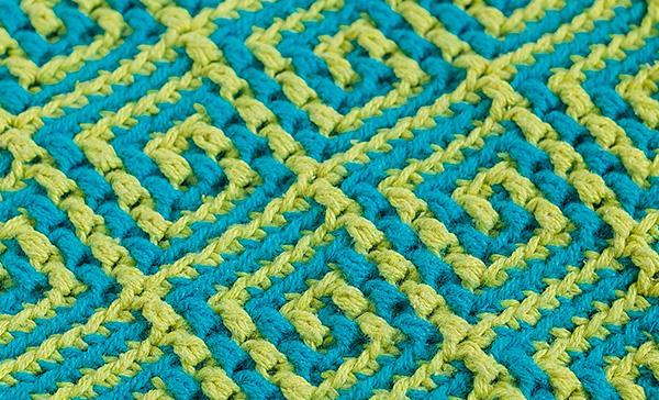 Knitted jacquard fabric with yellow blue geometric pattern