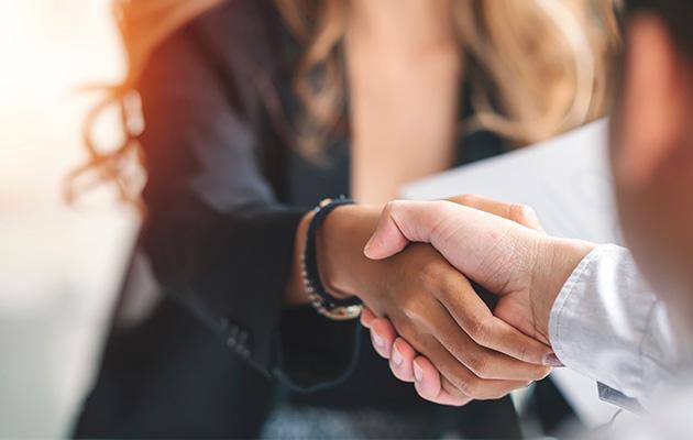 Closeup of a business woman handshake